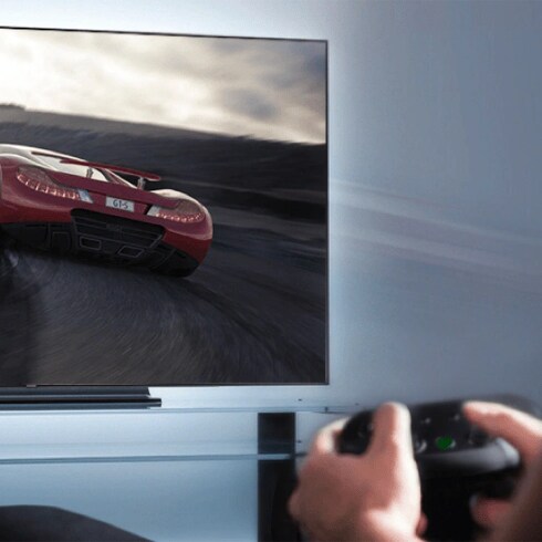 An illustrative image of a person playing gaming console connected to a tv.