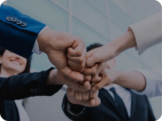 People from different backgrounds standing around and putting their hands together.